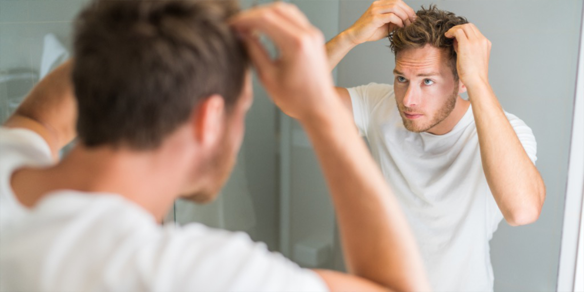 Man assessing hairline