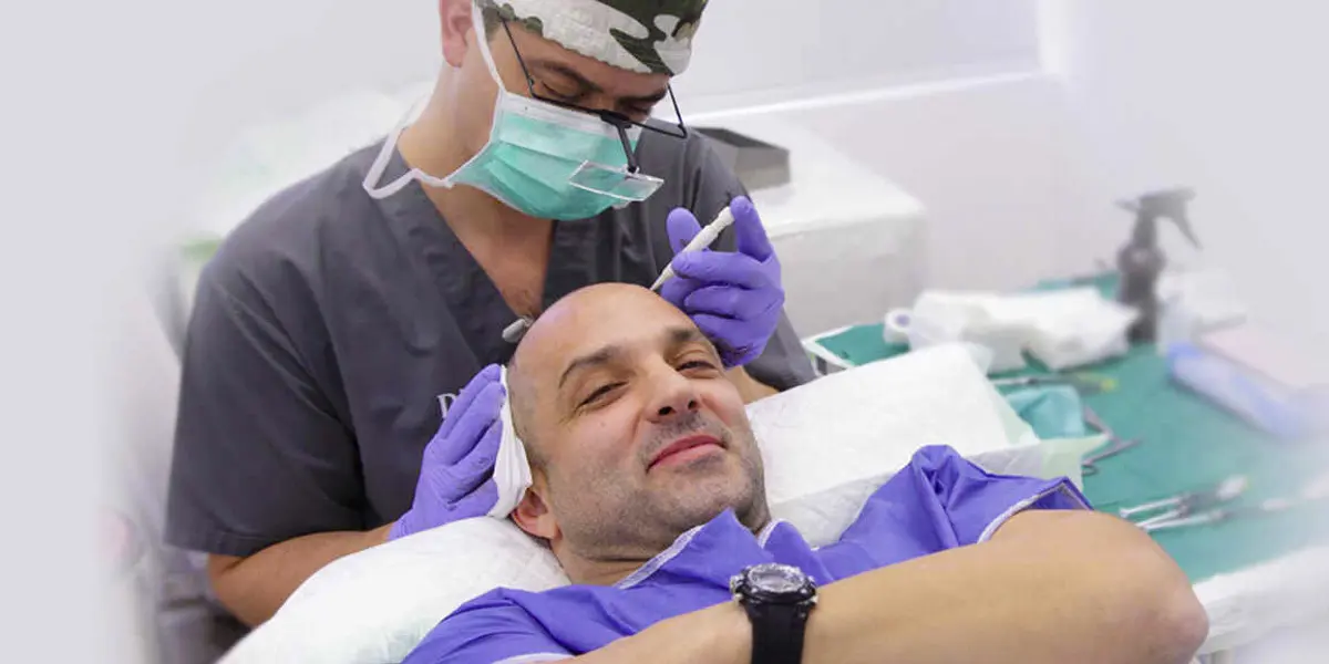 Man getting painless DHI hair transplant while watching movies